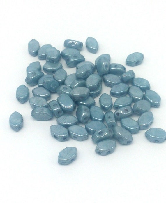 Last one.....Paros® Par Puca® Opaque Blue Ceramic Look, 2 hole beads 7 x 4mm, 102 beads